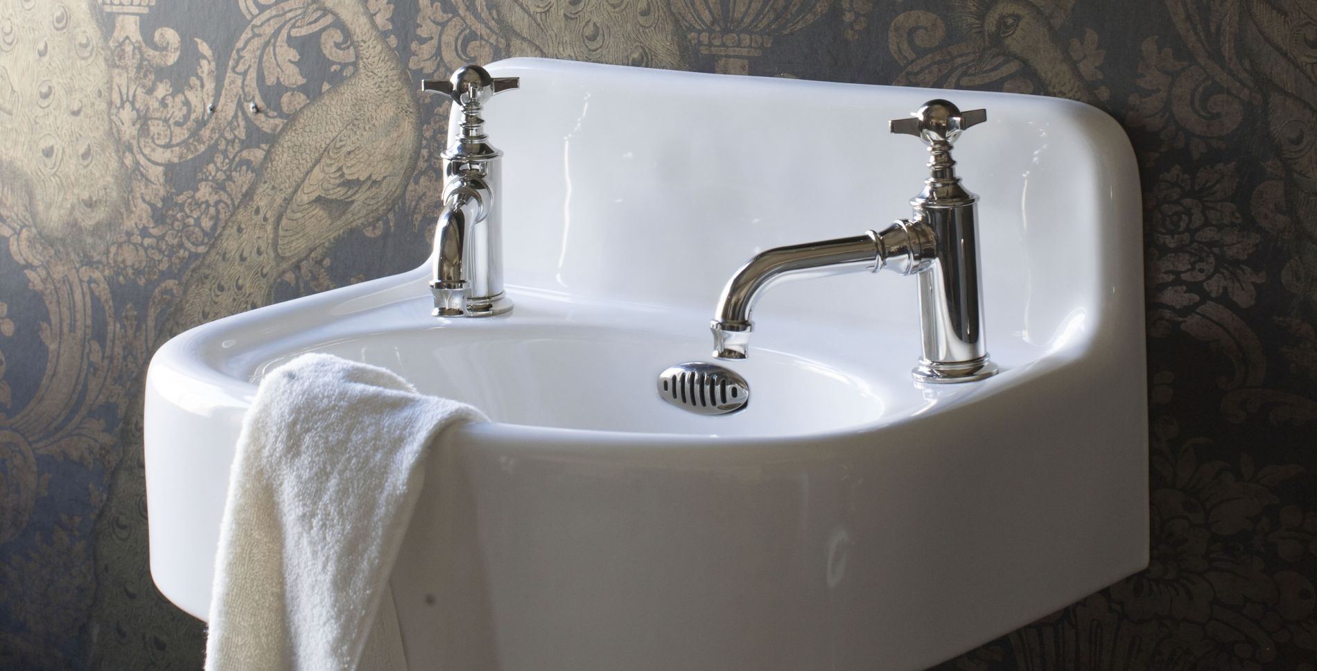 White basin with traditional taps. 