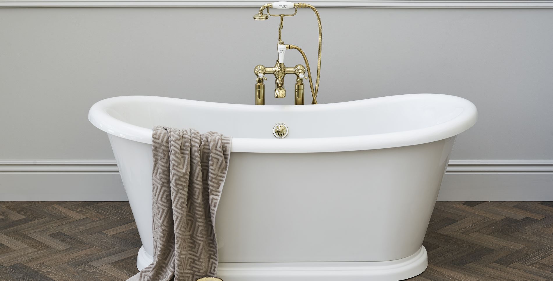 White bathtub with brass fixtures. 