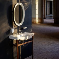 Washbasin with frame and illuminated oval mirror. 
