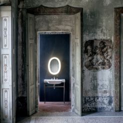 Washbasin and stand with illuminated oval mirror. 
